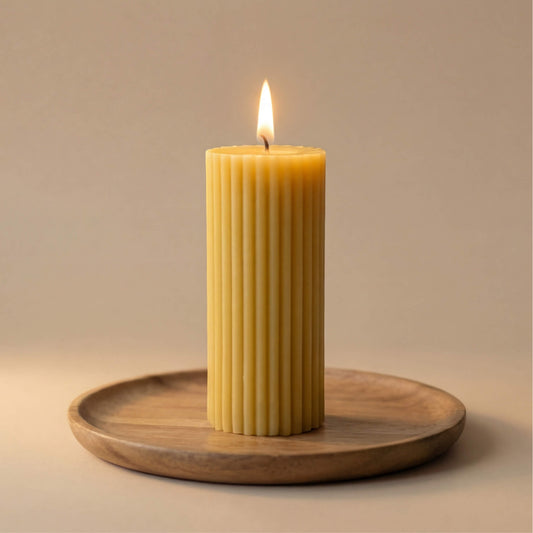 Natūralios spalvos cilindrinė bičių vaško žvakė „Rievėtas Stulpelis“ ant medinės lėkštės